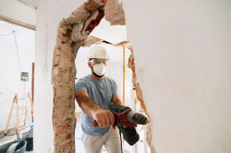 worker demolishing a wall